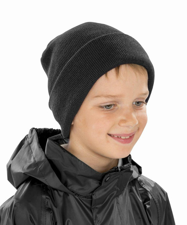 A smiling child wearing a Result RC29J beanie and a black raincoat.