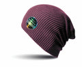 The RC31X by Result Winter Essentials is a textured, dark red slouchy beanie adorned with a black circular patch displaying the text "Softtex Denim & Goods" along with retro-style design elements on its side. The beanie is beautifully photographed against a white background.
