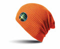 RC31X by Result Winter Essentials is an orange knit beanie adorned with a small round patch in black and silver text. The hat showcases a casual, slouchy style and appears to be hovering against a plain white background, casting a gentle shadow beneath it.