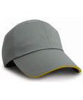 RC38X by Result Headwear, a gray baseball cap featuring yellow trim on the brim, shown from a slight side angle.