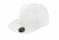 A plain white snapback hat, the RC83X by Result Headwear, features a flat brim. A small holographic sticker on the brim displays the brand name and logo. The hat is presented against a white background.
