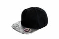 A black RC87X snapback hat from Result Headwear, featuring a gray marble-patterned brim and a SWAG sticker on the visor.