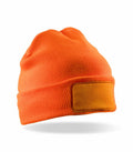 A beanie in orange featuring a blank rectangular patch on the front, set against a white background. This item is the RC934 from Result Genuine Recycled.