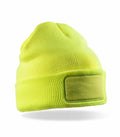 The RC934 from Result Genuine Recycled is a bright yellow knit beanie featuring a rectangular patch on the front.