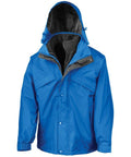Introducing the RE68A by Result: a vibrant blue waterproof jacket that boasts a detachable hood and front zip closure. It is designed with multiple pockets and includes a black inner fleece lining for enhanced warmth. The hood is lined with a slim layer of black fabric for extra protection.