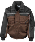 Introducing the RE71A by Result Workguard: a brown and black work jacket, equipped with multiple pockets, a high collar, and accented with white piping. This jacket is designed with snap buttons and features a sleeve pocket on the left arm for added functionality.