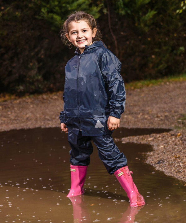 A child in a dark Result RE95J raincoat and pink boots stands happily in a large mud puddle.