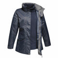 The RG111 from Regatta Professional is a dark blue waterproof jacket featuring a stand-up collar and a partially open visible zipper that reveals a matching fleece interior. It comes with two front pockets and adjustable cuffs.