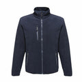 The RG112 by Regatta Professional is a navy blue fleece jacket featuring a full zip front and three zippered pockets, displayed against a white background.