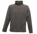 The RG138 by Regatta Professional is a dark gray fleece jacket featuring a high collar and a full-length zipper. It has long sleeves and two side pockets, displayed against a plain white background.