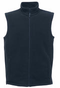 The RG185 by Regatta Professional, a black fleece vest featuring a zipper and two side pockets, is displayed against a plain background.