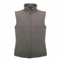 The RG185 from Regatta Professional is a gray fleece vest with no sleeves and a zip-up front, featuring a high collar. Its plain design includes two side pockets, making it perfect for layering in cool weather. The product is showcased against a plain white background.