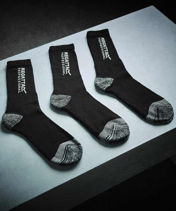 Three black Regatta RG287 socks with gray heels and toes are displayed on a white surface.