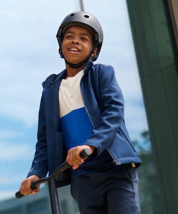 A boy wearing a blue jacket and helmet is riding a Regatta RG332 outdoors.