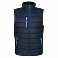 Introducing the RG340 by Regatta Professional: a black padded vest accented with blue zippers and trim, designed with a high collar for added warmth. This stylish vest features three zippered pockets and a quilted design, making it an ideal choice for cold weather.
