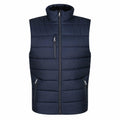The RG340 by Regatta Professional is a sleeveless puffer vest in navy blue, designed with a high collar and zippered front. It includes two zippered pockets on each side and an additional vertical zippered pocket on the chest.