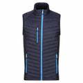 Introducing the RG341 by Regatta Professional: a navy blue, sleeveless quilted vest featuring stylish light blue zippers. This vest is designed with two side pockets, a chest pocket, black side panels, and a high collar for added comfort and style.
