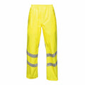 Regatta High Visibility RG386 pants in bright yellow, featuring waterproof material and reflective silver stripes on the legs.