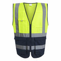 The RG469 safety vest by Regatta High Visibility features bright yellow on the upper half and dark blue on the lower half, complete with reflective horizontal and vertical stripes. It includes a black zipper, multiple pockets, and is designed without sleeves.