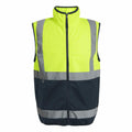 The RG472 safety vest from Regatta High Visibility features a bright yellow top half paired with a dark bottom half. It is designed with reflective silver stripes across the chest and waist, along with a full front zipper. Additionally, the vest includes a high collar and is sleeveless for optimal comfort.