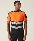 A man faces forward wearing the Regatta High Visibility Hi-Vis X-Pro T-shirt (Class 1), a short-sleeved, bright orange and black shirt with silver and black chevron stripes. He looks to his left with arms relaxed at his sides.