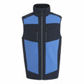 The RG543 vest by Regatta Professional is a sleeveless piece with a high collar and a front zipper. It showcases a color-block design, combining blue panels on the chest and sides with contrasting black sections. Additionally, it features multiple zippered pockets on the front for added functionality.