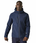 A person is wearing a navy blue Regatta RG594 hooded jacket with zippered pockets, standing against a plain white background.