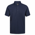 The RG616 by Regatta Professional is a navy blue short-sleeved polo shirt featuring a collar and three buttons down the front, displayed on a plain white background.