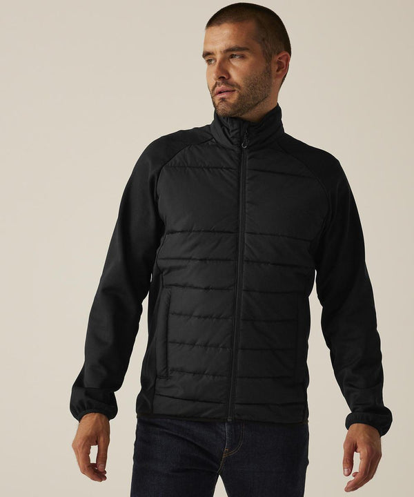 A man with short hair and a beard is wearing the Regatta Professional Essential hybrid jacket and dark jeans. He stands against a neutral background, looking to his left.