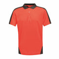 Introducing the RG663 by Regatta Professional: a vibrant orange polo shirt featuring a black collar, shoulder accents, and hem details. This short-sleeved style is complemented by a classic three-button placket.