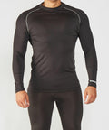 A person wearing a fitted long-sleeve black RH001 by Rhino and black leggings stands against a plain white background.