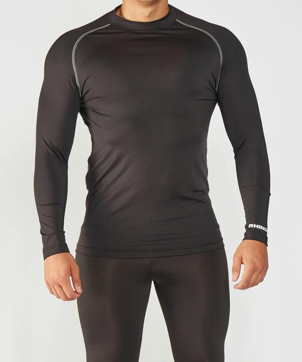 A person wearing a fitted long-sleeve black RH001 by Rhino and black leggings stands against a plain white background.