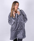 A person wearing an oversized gray fleece hoodie with a white lining, Ribbon's RI002, posing against a plain, light-colored background.