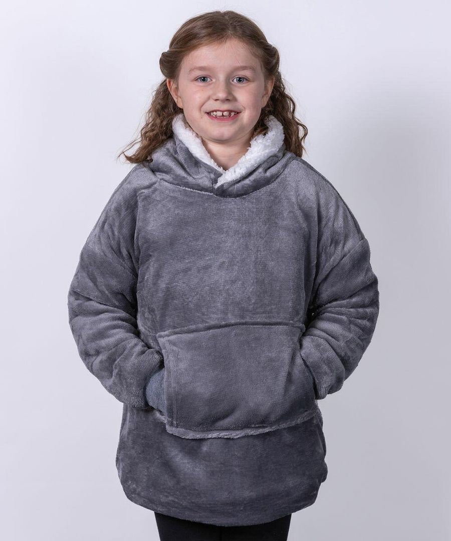 A young girl smiling, wearing a grey plush hooded Ribbon RI003 sweatshirt with her hands in the front pocket.