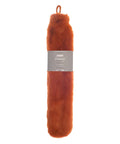 A brown, rectangular faux fur-covered hot water bottle with a top loop and a grey “luxury” label is shown against a white background.