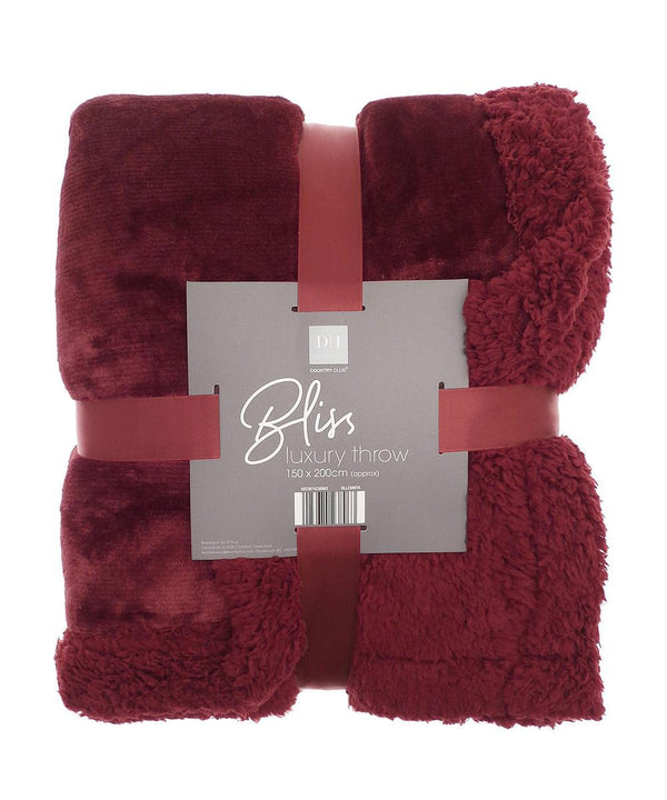 A folded dark red Sherpa winter throw with a soft, plush texture, wrapped in a matching red ribbon. The label displays "Ribbon" as the brand name and specifies the size as 150 x 200 cm.