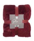 A folded burgundy Blankets plush throw, 150 x 200 cm, with a smooth top, fluffy underside, and matching ribbon. The front label reads "Bliss Luxury Throw.