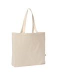 A beige canvas tote bag named "Bags," featuring two handles and a small green tag on the right side, stands empty and upright against a white background.