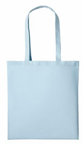 The RL100 by Nutshell is displayed against a plain white background, showcasing its light blue fabric and long handles. The tote bag's simplicity emphasizes its color and texture.
