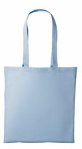 A Nutshell RL100 tote bag in light blue canvas is showcased against a white backdrop. The bag, featuring long handles, is shown empty and lying flat to highlight its simple and minimalist design.