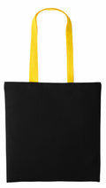 A Nutshell RL150, a black tote bag featuring long yellow handles.