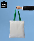 A person in a black suit holds a Nutshell RL150 with green handles against a blue background.