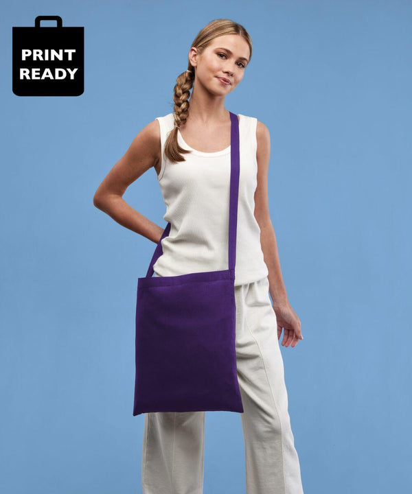 Person wearing a white top and pants, carrying a purple shoulder bag against a blue background. An icon that reads "Print Ready" is displayed in the top left corner. The Nutshell RL400 is prominently featured in the scene.