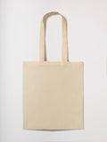 The RL600 tote bag by Nutshell, featuring a minimalist beige design with long handles, lies flat on a white background, showcasing its simple style without any visible patterns or logos.