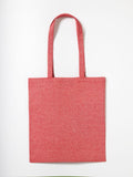 The Nutshell RL600 tote bag in red, featuring long handles, is displayed flat on a simple white background. The fabric has a textured, woven look.