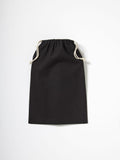 A Nutshell RL700 drawstring pouch in black with white cords, set against a plain white background.