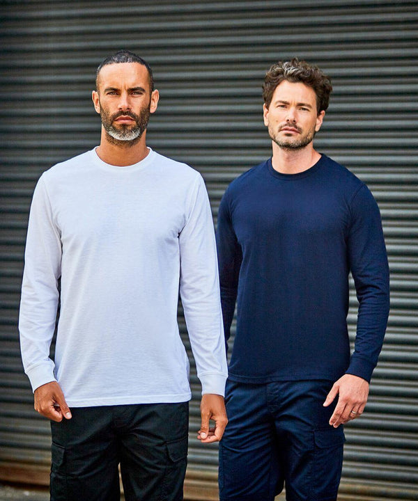 Two men with beards stand side-by-side in front of a metal roller door; one wears a white long-sleeve RX152 shirt and black pants, the other wears a navy long-sleeve RX152 shirt and matching pants by ProRTX.