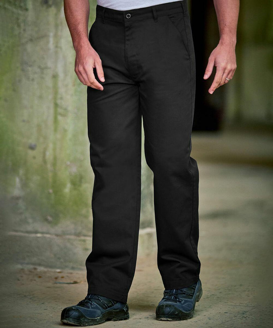 Person wearing ProRTX RX601 black pants and black shoes stands near a greenish wall.