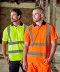 Two men wearing reflective safety shirts, one in lime green and the other in orange, stand indoors in a construction setting. They are both dressed in the RX710 by ProRTX.