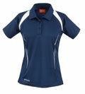 The Spiro S177F is a navy blue short-sleeved polo shirt featuring white accents on the shoulders and underarms. It comes with a button-up collar and small white decorative dots along the sides.